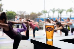 Yoga poses with a beer in the foreground